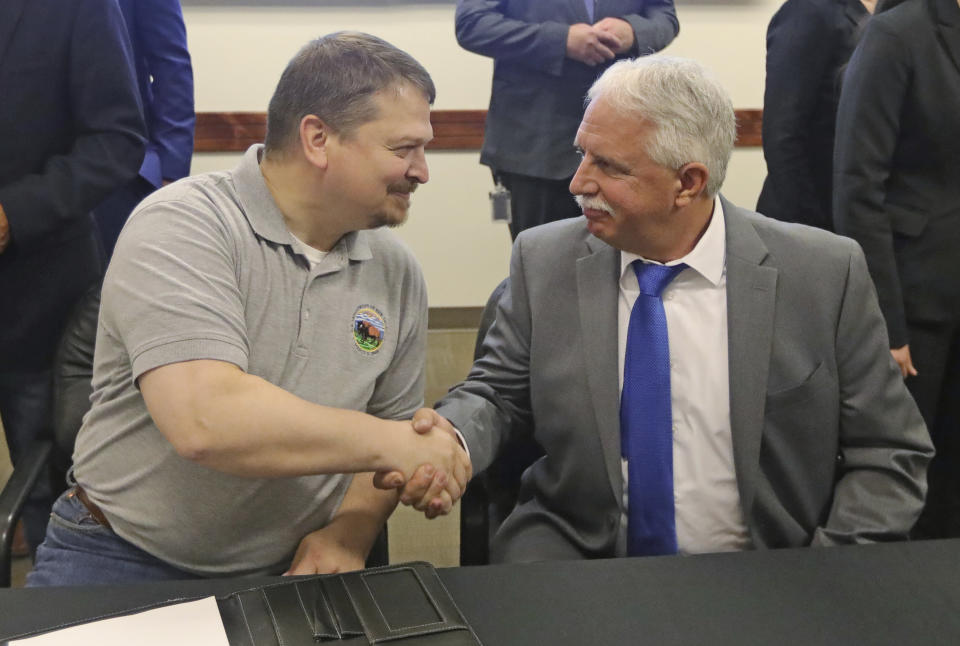 Joe Balash, left, the former assistant secretary for land and minerals management at the Interior Department, shakes hands with John Mansanti, president and CEO of Crystal Perk Minerals, in August 2019. Balash was hired by a foreign oil company weeks after his resignation from the federal agency. (Photo: ASSOCIATED PRESS)