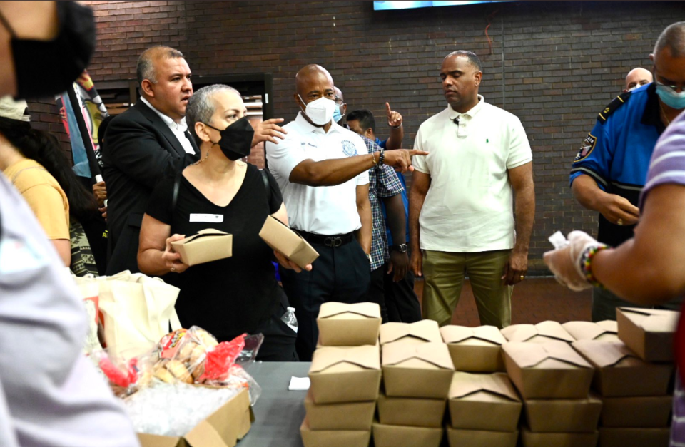 New York City officials including Mayor Eric Adams (at center pointing) said they are struggling to accommodate a surge in migrants as Texas begins busing them to the city.