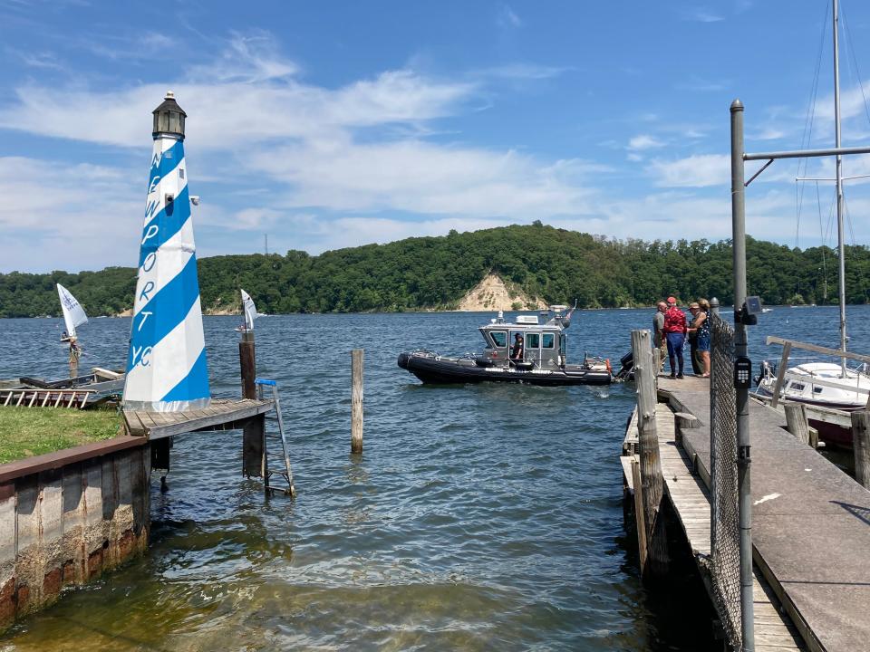 A patrol boat from the Monroe County Sherriff's Office floats above a vehicle that submerged in Irondequoit Bay on June 13, 2021.