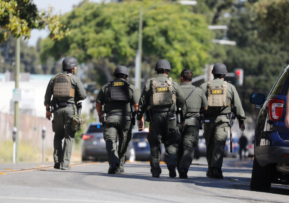 Santa Clara County Sheriff Police Officers walk along North San Pedro Street after a shooting at the VTA light rail yard in San Jose, California.