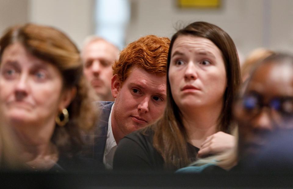 Members of the gallery including Buster Murdaugh, the son of Alex Murdaugh, look at phone details displayed on a television screen as part of the evidence in the Alex Murdaugh trial at the Colleton County Courthouse in Walterboro, Wednesday, Feb. 15, 2023. Grace Beahm Alford/The Post and Courier/Pool