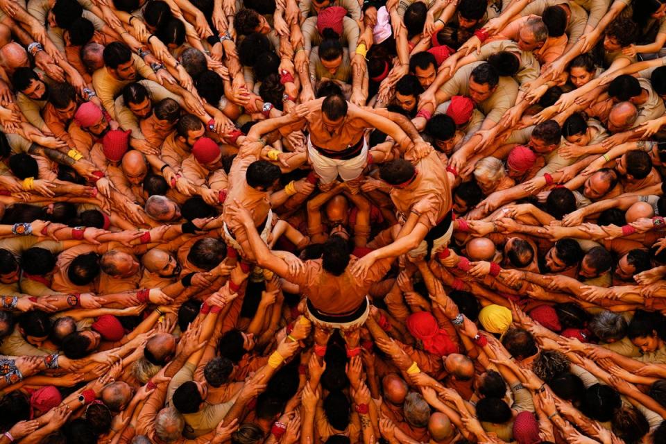 Members of the ‘Colla Xiquets de Reus’ team form their human tower during the Castells contest final in Tarragona, Catalonia, Spain (EPA)