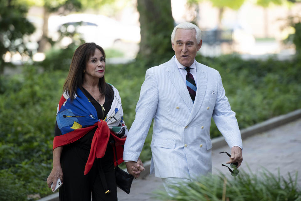 Roger Stone, a longtime confidant of President Donald Trump, accompanied by his wife Nydia Stone, left, arrives at federal court in Washington, Tuesday, July 16, 2019. (AP Photo/Sait Serkan Gurbuz)