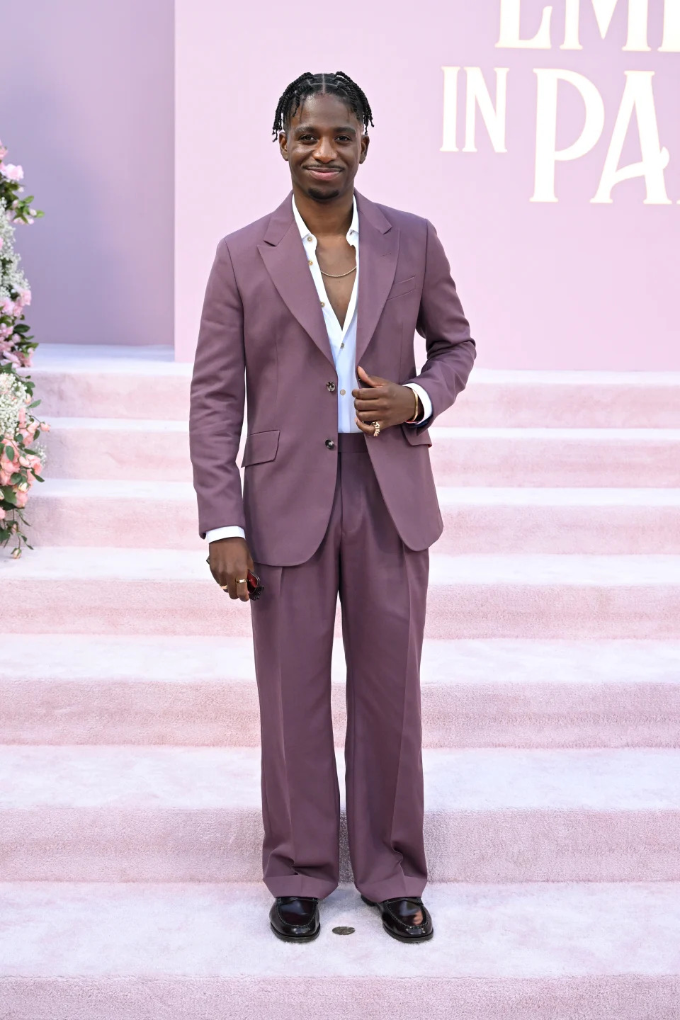 Samuel Arnold in a purple suit at the premiere of "Emily in Paris"