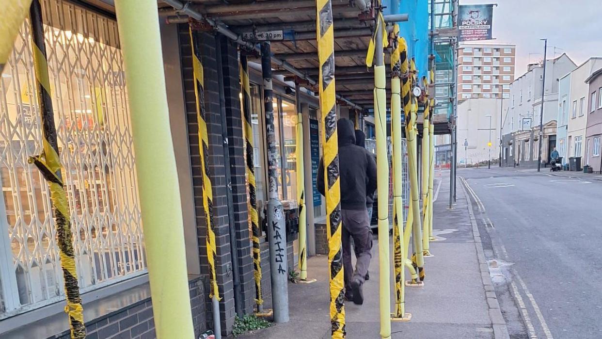 Man waiting to enter Tesco store on North Street in Southville