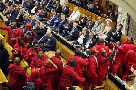 Members of the opposition Economic Freedom Fighters (EFF) party leave the parliamentary chamber as South Africa's President Jacob Zuma delivers his State of the Nation address in Cape Town, February 11, 2016. REUTERS/Schalk van Zuydam/Pool