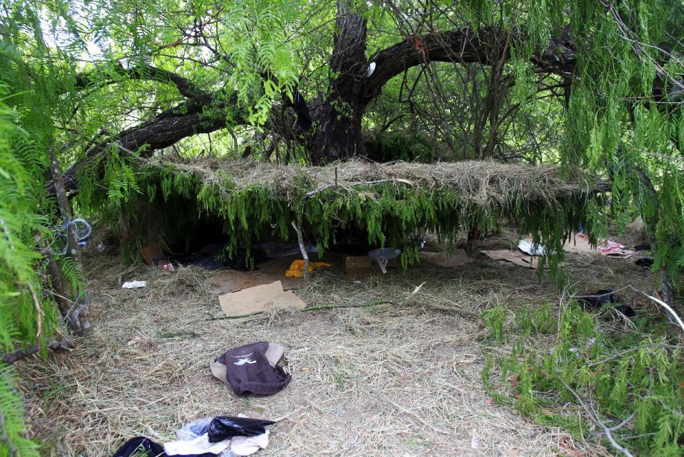 A hut made out of grass and tree limbs are viewed after U.S. Border Patrol agents detained about 75 immigrants who'd been living in hut for several days in a brushy area Thursday April 17, 2014 near North 10 St. and Sprague St. in McAllen, Texas. Agents spent about three hours rounding up the immigrants suspected of being in the country illegally after they responded to the area. Most of the immigrants are believed to be from Central America. (AP Photo/The Monitor, Gabe Hernandez)