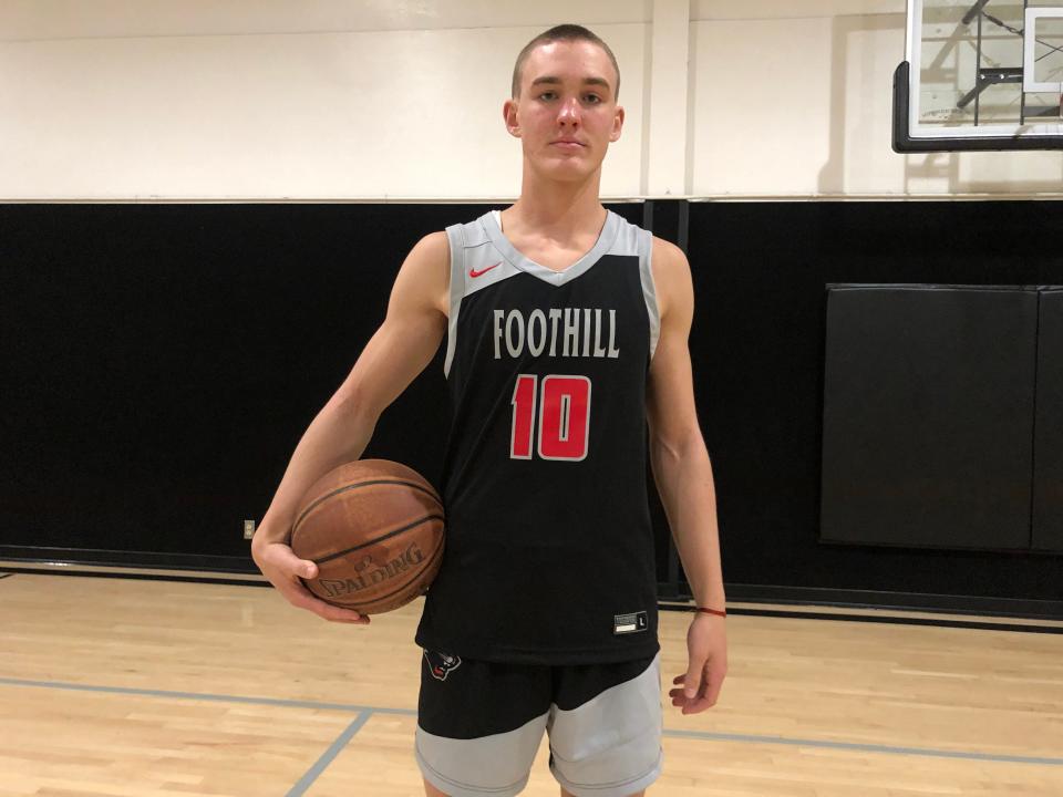 Foothill junior guard Asa Arnold holds a basketball at the Shasta Family YMCA on Wednesday, Dec. 21, 2022.