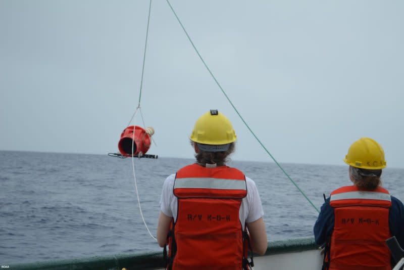 Technicians deploy an improved OneArgo float that dives deeper and collects more data than older Argo floats. Photo courtesy of NOAA