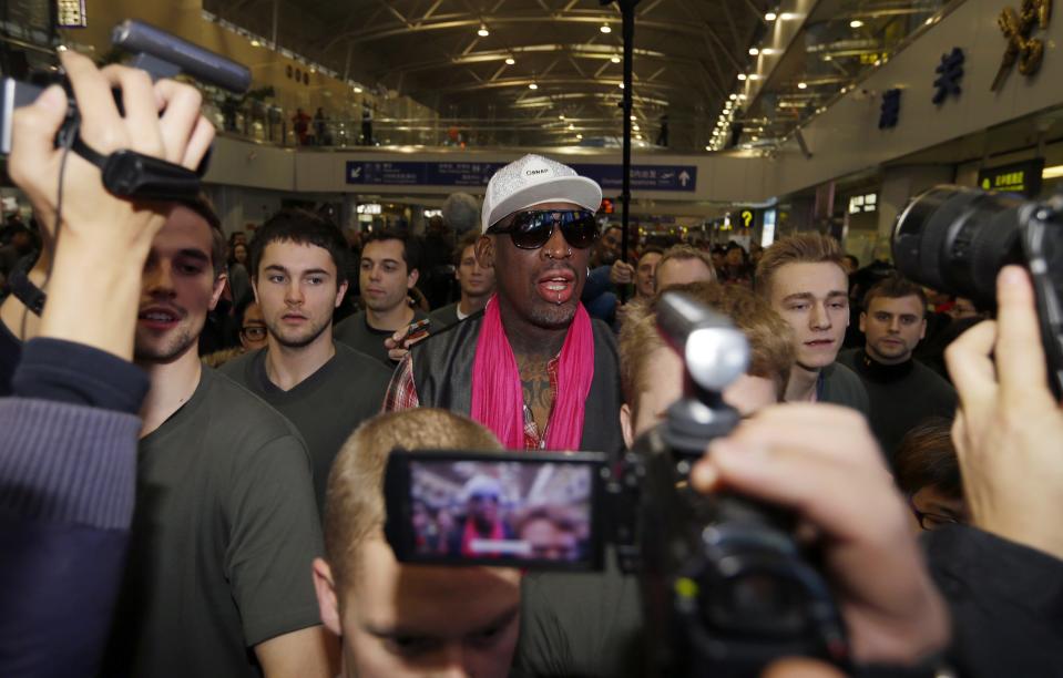 Former NBA basketball player Dennis Rodman talks to journalists as he arrives at the Beijing Capital International Airport to leave for Pyongyang, in Beijing