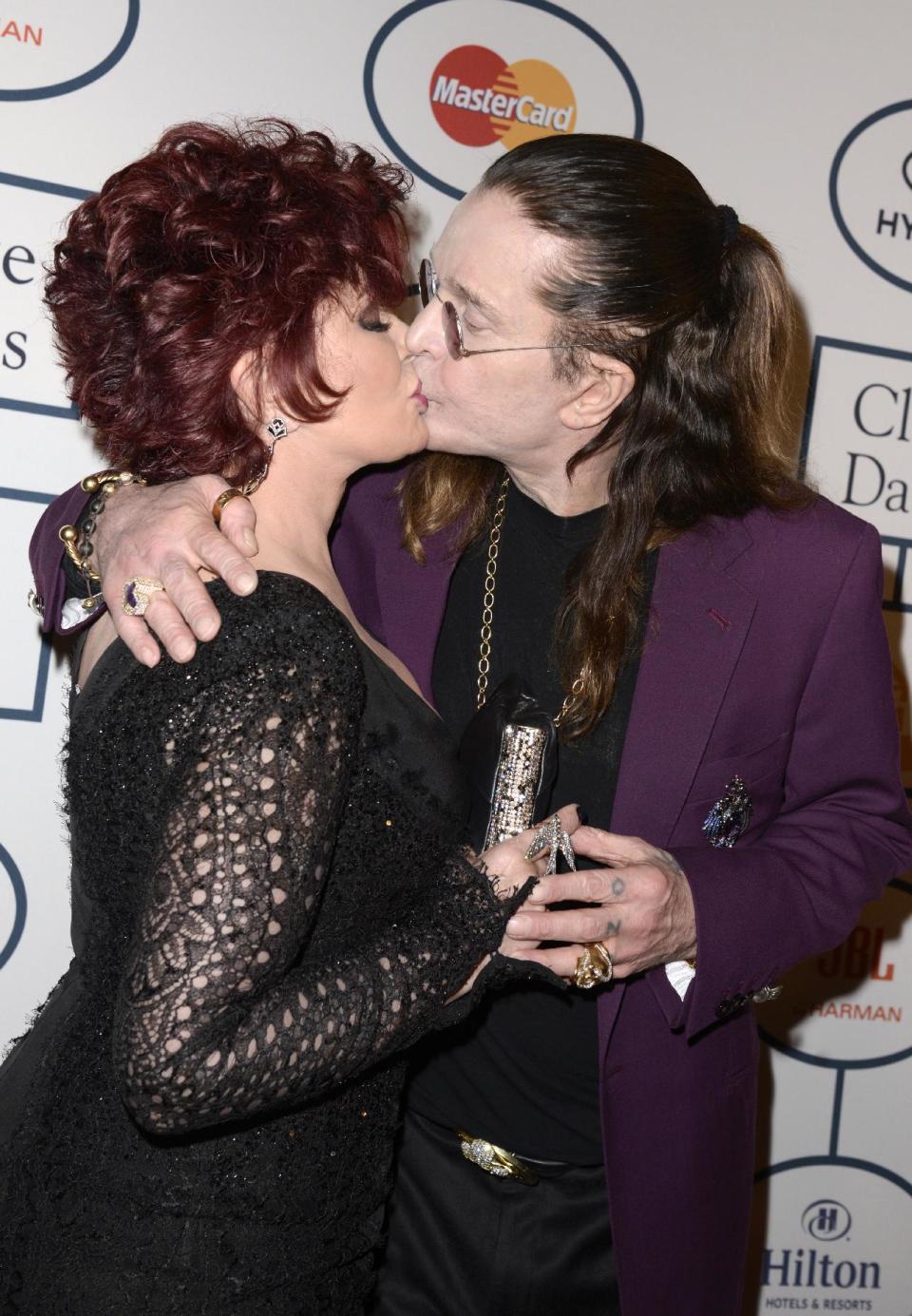 Sharon Osbourne, left, and Ozzy Osbourne kiss at the 56th annual GRAMMY awards - salute to industry icons with Clive Davis, on Saturday, Jan. 25, 2014, in Beverly Hills, Calif. (Photo by Dan Steinberg/Invision/AP)