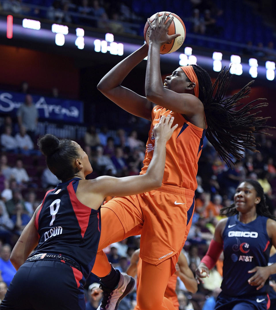 FILE - In this June 11, 2019, file photo, Connecticut Sun center Jonquel Jones shoots over Washington Mystics guard Natasha Cloud during a WNBA basketball game in Uncasville, Conn. Connecticut has risen back to the top of the standings behind solid play from Jonquel Jones and Alyssa Thomas. (Sean D. Elliot/The Day via AP, File)