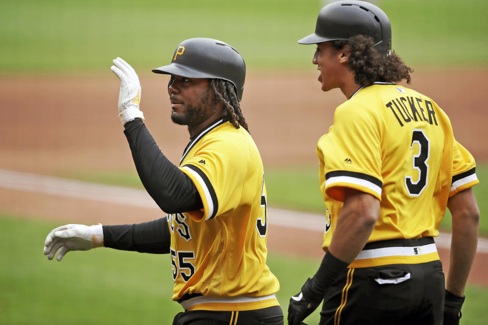 CPittsburgh Pirates' Josh Bell, left, heads back to the dugout with Cole Tucker after hitting a two-run home run off San Francisco Giants starting pitcher Dereck Rodriguez in the  fourth inning  of a baseball game in Pittsburgh, Sunday, April 21, 2019. (AP Photo/Gene J. Puskar)