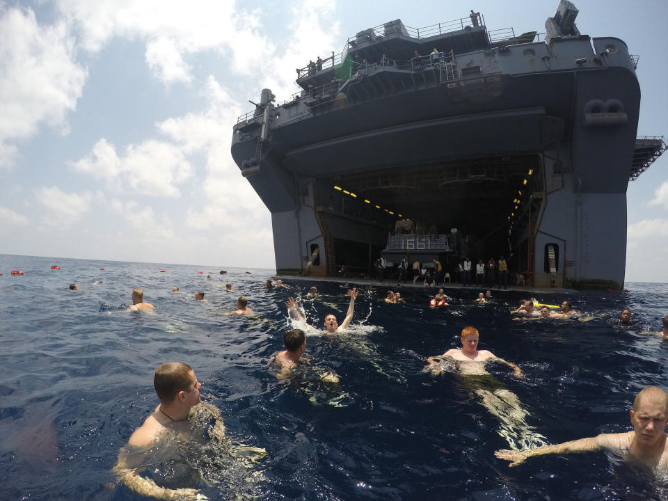 Sailors and Marines aboard the amphibious assault ship USS Iwo Jima participate in a swim call in the Gulf of Aden, April 18, 2015. 