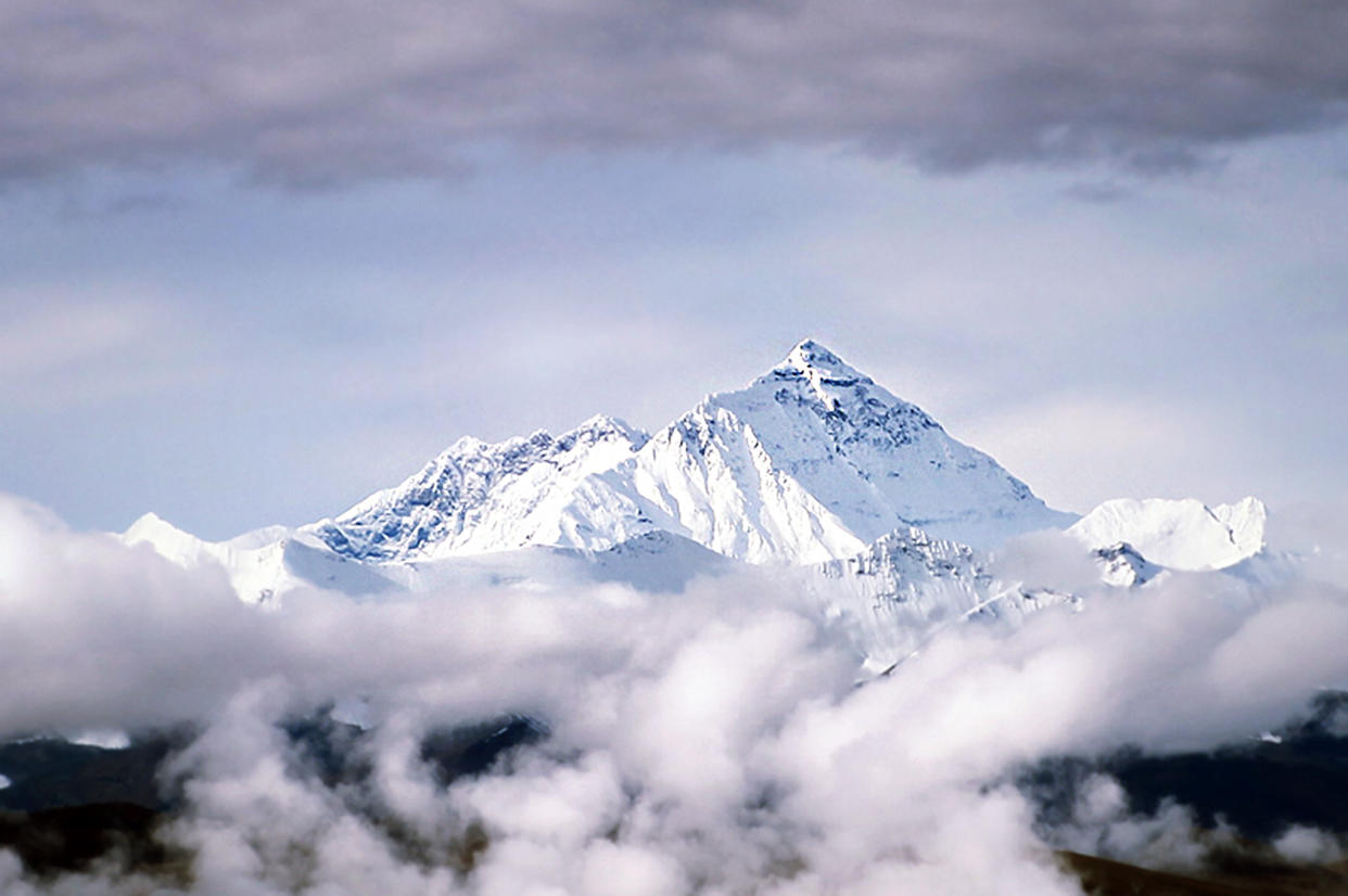 Peak of Mount Everest Above Clouds in Tibet.