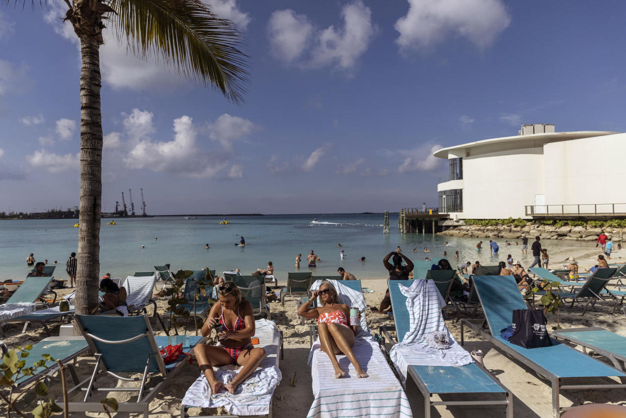 Tourists at a beach in Nassau, Bahamas (Victor J. Blue / Bloomberg via Getty Images)