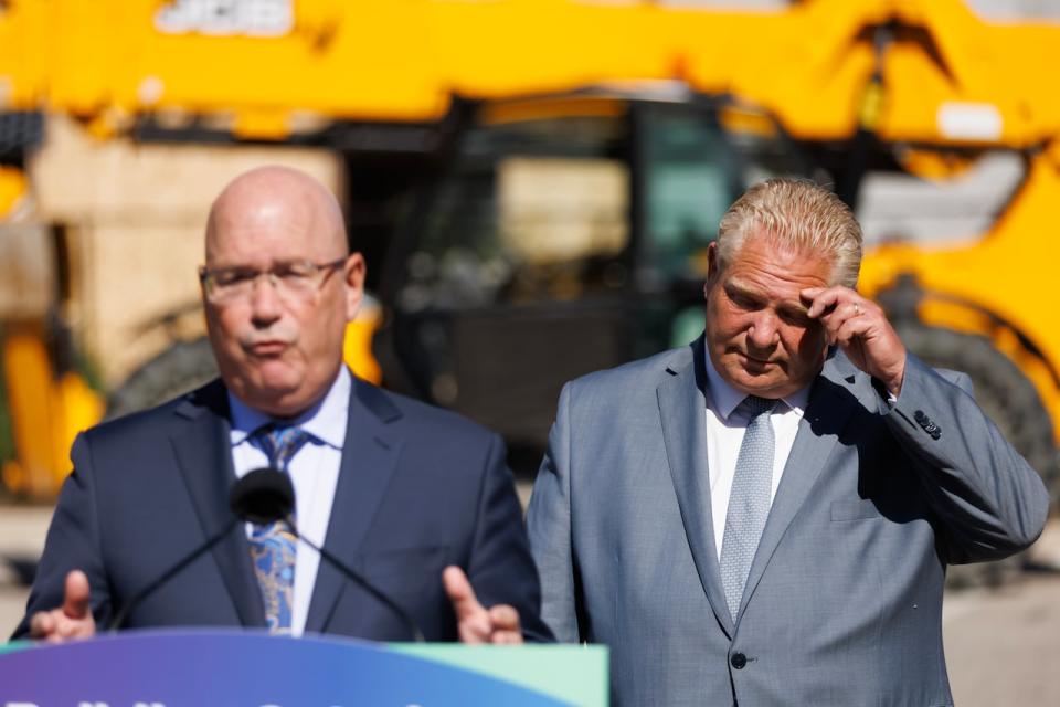 Ontario Premier Doug Ford listens as Ontario’s minister of housing Steve Clark speaks during a press conference in Mississauga, Ont., Friday, Aug. 11, 2023.