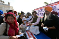 Delhi Sikh Gurdwara Management Committee members distribute face masks, as a preventive measure for coronavirus.