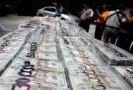 FILE PHOTO: Packages of money seized during an operation are shown to the media at a military zone on the outskirts of Monterrey