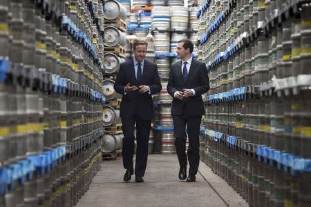 Britain's Prime Minister and Conservative Party leader David Cameron (L) walks with Chancellor George Osborne during their visit to Marston's Brewery in Wolverhampton, central England April 1, 2015. REUTERS/Leon Neal/pool