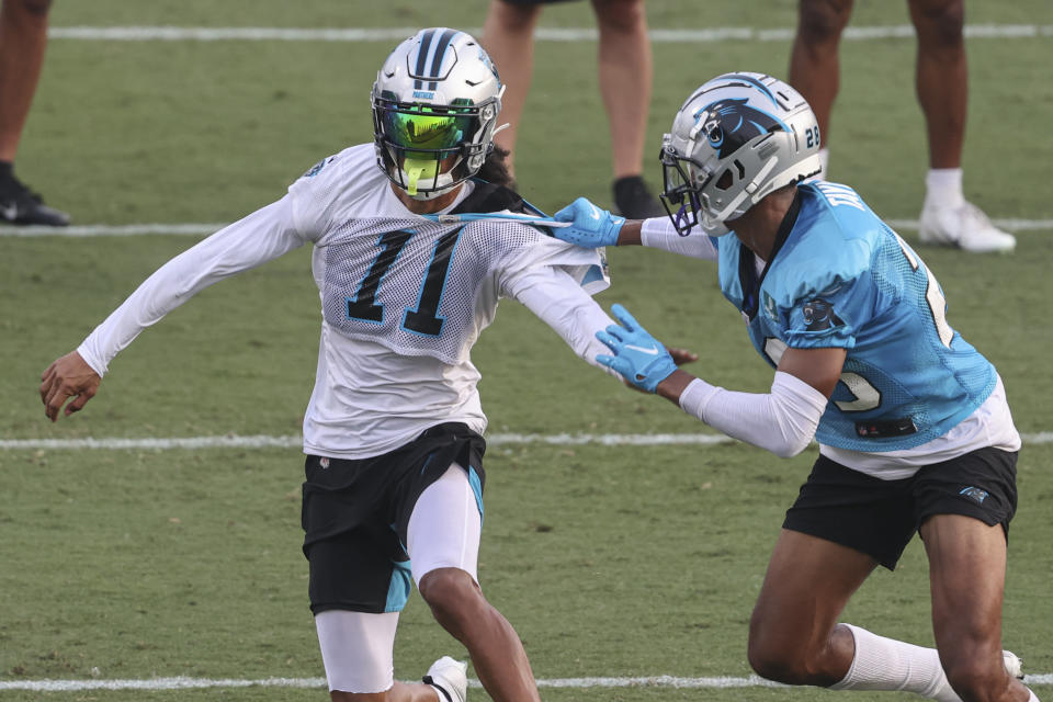 Carolina Panthers wide receiver Robby Anderson, left, and linebacker Jeremy Chinn battle for position during practice at Back Together Saturday at the NFL football team's training camp in Spartanburg, S.C., Saturday, July 31, 2021. (AP Photo/Nell Redmond)