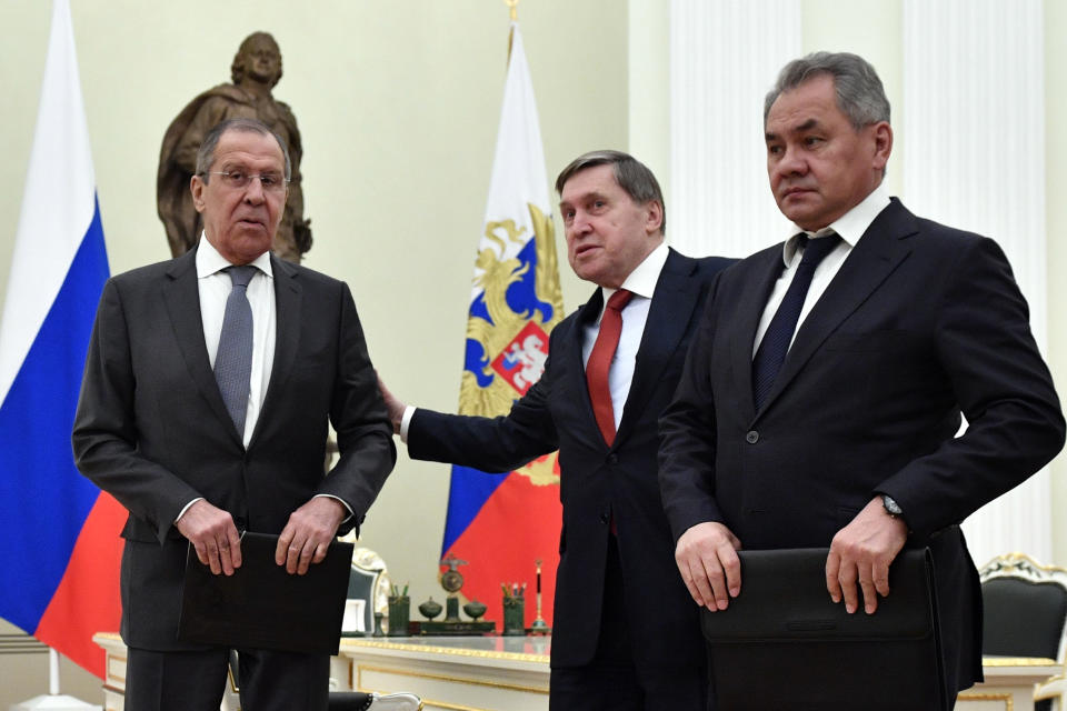 FILE - Russian Foreign Minister Sergey Lavrov, left, presidential aide Yury Ushakov, center, and Defense Minister Sergei Shoigu wait for the beginning of the Russia-Turkey talks in the Kremlin iin Moscow, Russia, Jan. 23, 2019. While demanding a halt to NATO's eastward expansion, Moscow has also urged the U.S. and its allies not to deploy weapons or conduct any military activities in Ukraine and other ex-Soviet nations. (Alexander Nemenov/Pool Photo via AP, File)