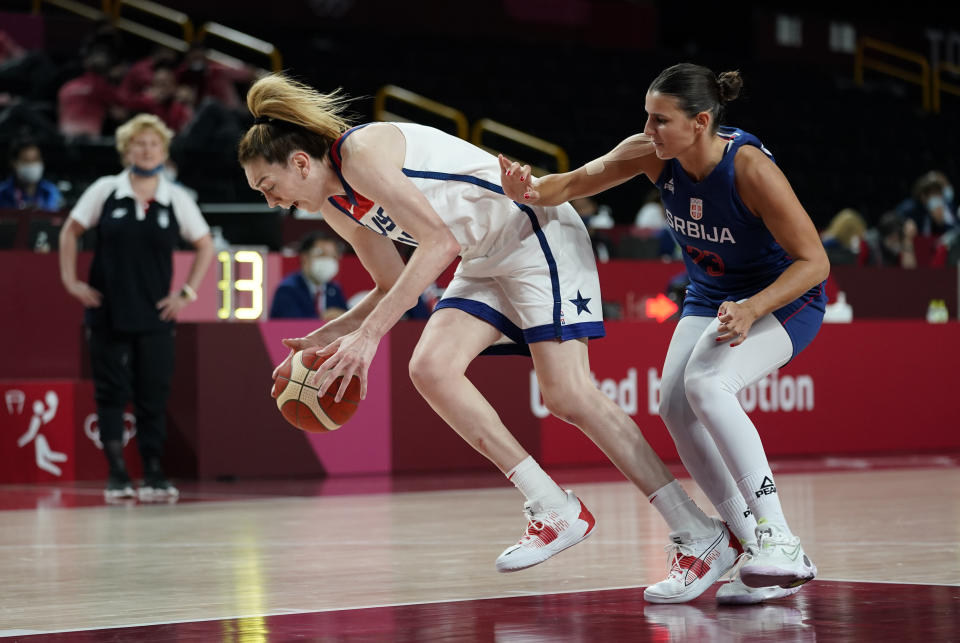 United States' Breanna Stewart (10), left, drives past Serbia's Ana Dabovic (23) during women's basketball semifinal game at the 2020 Summer Olympics, Friday, Aug. 6, 2021, in Saitama, Japan. (AP Photo/Charlie Neibergall)