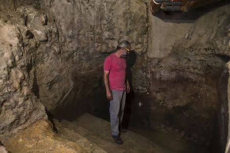 Ein Karem resident, Tal, stands in a ritual bath that was discovered under his family's house in Jerusalem, July 1, 2015. REUTERS/Ronen Zvulun