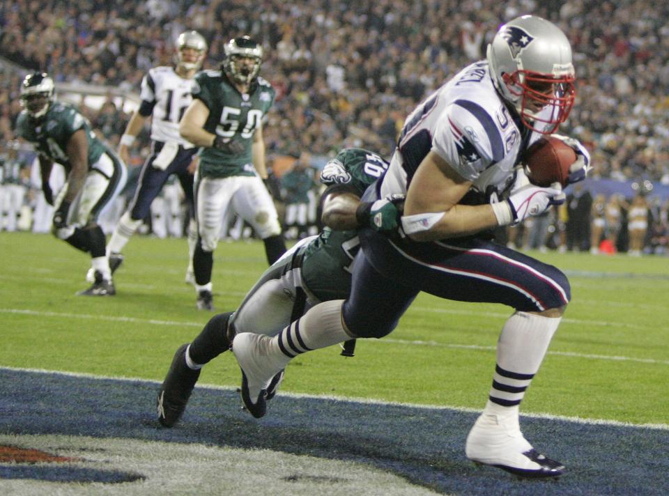 New England Patriots' Mike Vrabel hauls in a 2-yard touchdown pass from quarterback Tom Brady (12) behind Philadelphia Eagles' Quintin Mikell (46) in the third quarter of Super Bowl XXXIX in Jacksonville, Fla., Sunday, Feb. 6, 2005.