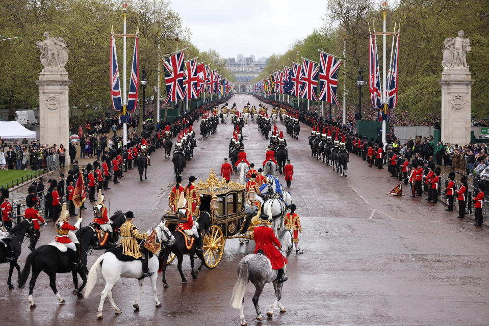 King Charles III and Camilla, Queen Consort, traveling in the Diamond Jubilee Coach, flanked by over a thousand Armed Forces route liners and The Sovereign’s Escort of the Household Cavalry sets off along the Mall from Buckingham Palace on route to Westminster Abbey.<span class="copyright">Dan Kitwood—Getty Images</span>