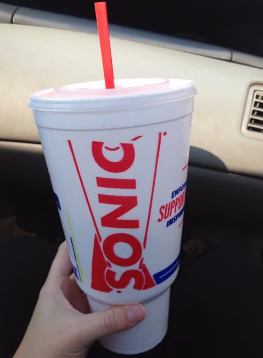 Person holding Sonic drink in a car