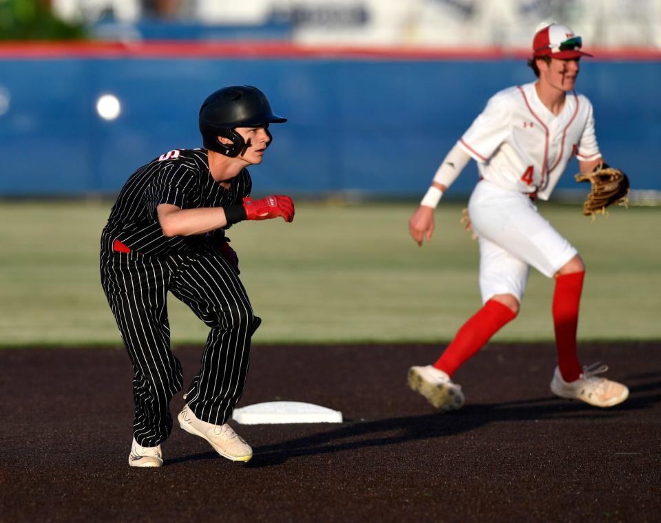 Anson freshman Stryker Dillard leads from the bag as Miles second baseman Carson Ellison moves to cover during Friday's game at Cooper High School. The Tigers won Game 1 of the best-of-3 bidistrict series 5-3.
