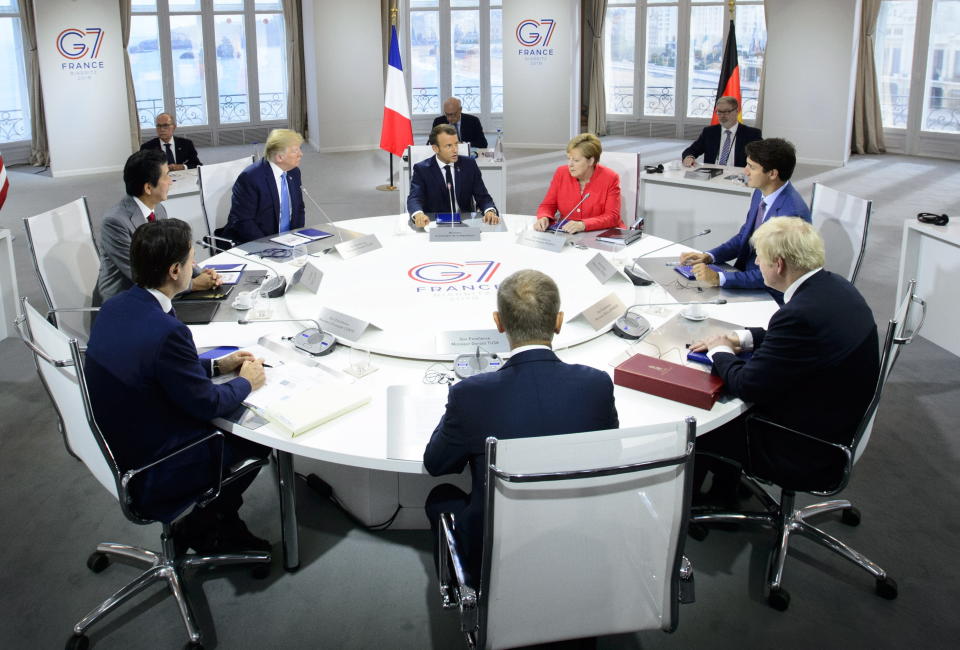 President of the European Council Donald Tusk, clockwise from center front, Italian Prime Minister Giuseppe Conte, Japan Prime Minister Shinzo Abe, U.S. President Donald Trump, President of France Emmanuel Macron, German Chancellor Angela Merkel, Canadian Prime Minister Justin Trudeau, and British Prime Minister Boris Johnson take part in a working session with G7 leaders on the second day of the G-7 summit in Biarritz, France Sunday, Aug. 25, 2019. (Sean Kilpatrick/The Canadian Press via AP)