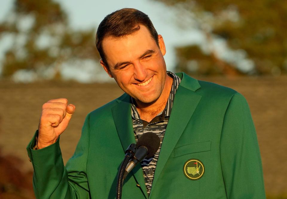 Scottie Scheffler talks to the patrons while wearing his green jacket after winning the Masters at Augusta National.