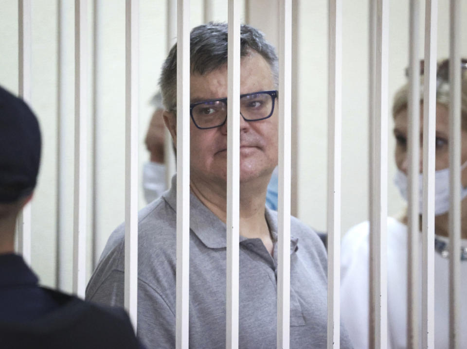 Viktor Babariko, the former head of Russia-owned Belgazprombank, stands inside a cage in a court room in Minsk, Belarus, Tuesday, July 6, 2021. The Supreme Court in Belarus has sentenced a former contender in the 2020 presidential race to 14 years in prison on corruption charges in a case that has been widely seen as politically motivated. Viktor Babariko, the former chief executive of a Russia-owned bank, aspired to challenge Belarus' authoritarian president Alexander Lukashenko in last year's election. (Ramil Nasibulin/BelTA Pool Photo via AP)