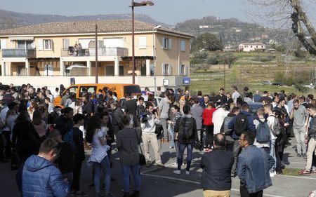 High school students stand near the Tocqueville high school after a shooting in Grasse, southern France, March 16, 2017. REUTERS/Eric Gaillard