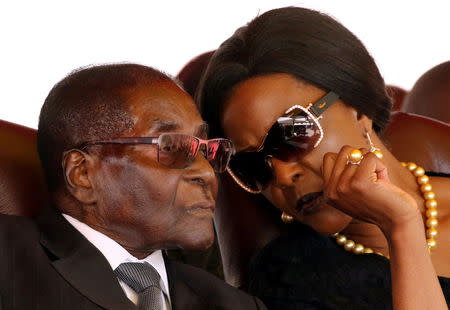 FILE PHOTO: President Robert Mugabe (L) and his wife Grace attend the burial of two independence luminaries, Maud Muzenda and George Rutanhire, in Harare, Zimbabwe August 26, 2017. REUTERS/Philimon Bulawayo/File Photo