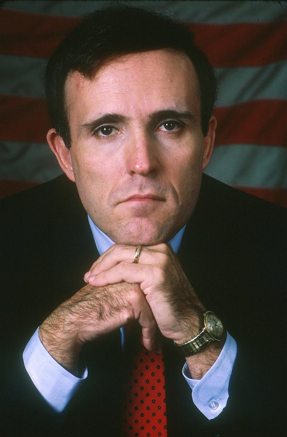 A young Giuliani poses with a watch on his wrist. He now owns dozens of valuable timepieces (Getty Images)