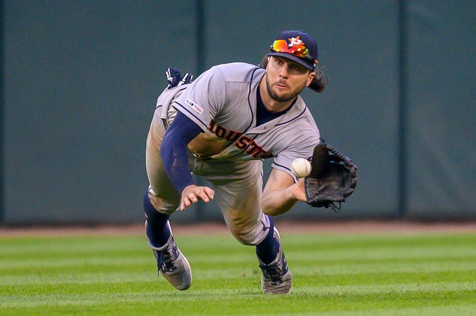 Houston Astros center fielder Jake Marisnick dives to catch Chicago White Sox left fielder Eloy Jimenez's fly ball during the ninth inning in game one of a baseball doubleheader at Guaranteed Rate Field in Chicago. 