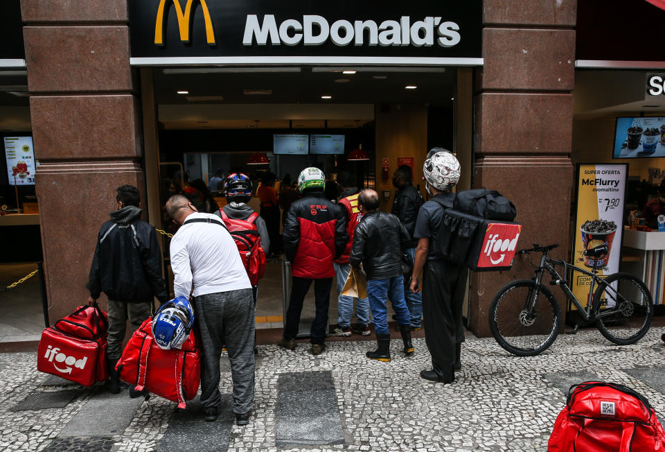 SAO PAULO, BRAZIL - MARCH 08: Food delivery couriers wait in line at a McDonald&#39;s restaurant in downtown during the first business day after the state of Sao Paulo declared the most restrictive 