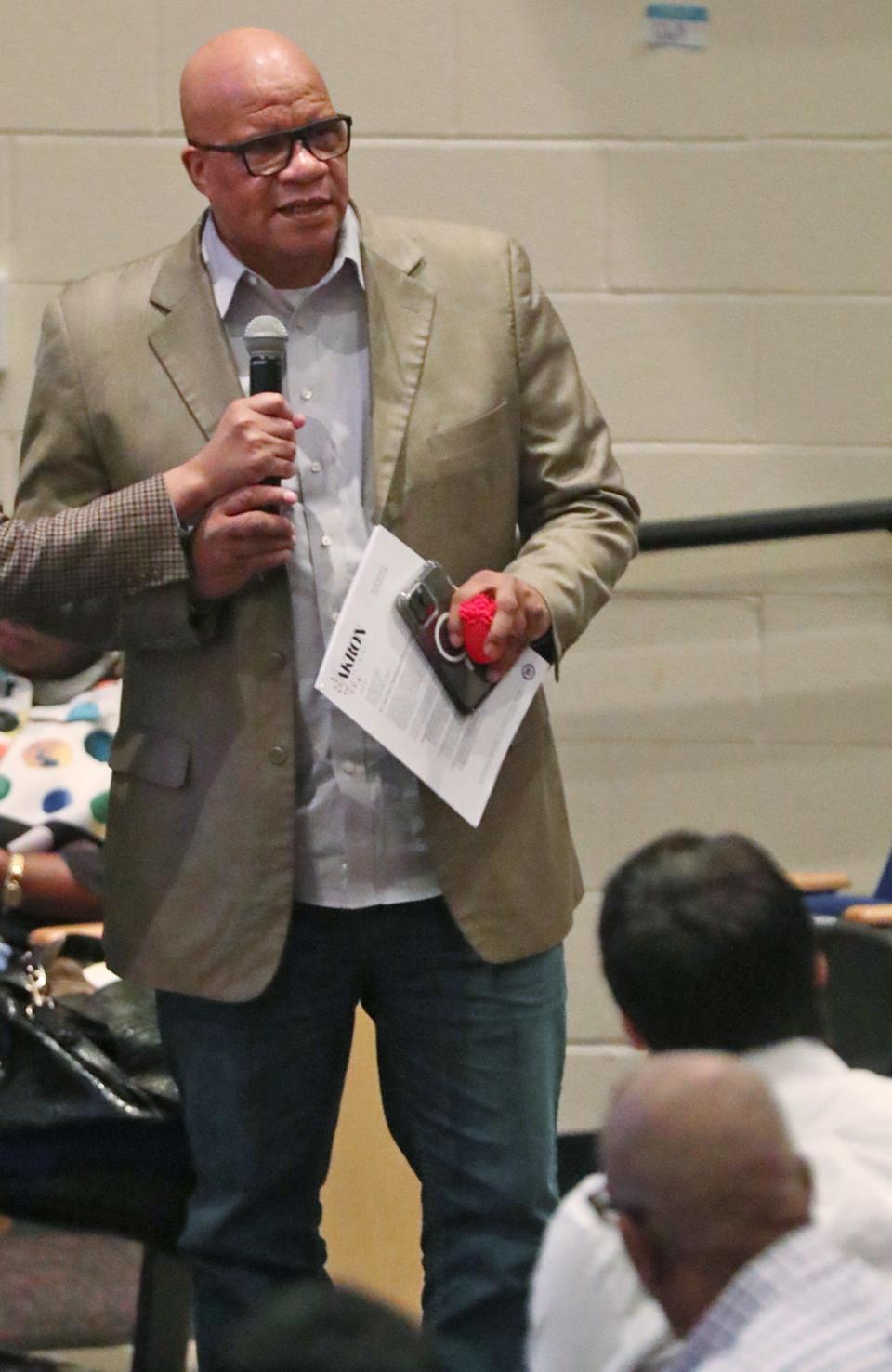 Pastor Gregory Harrison, a retired Akron police officer, speaks Tuesday evening during a community forum at Buchtel CLC.