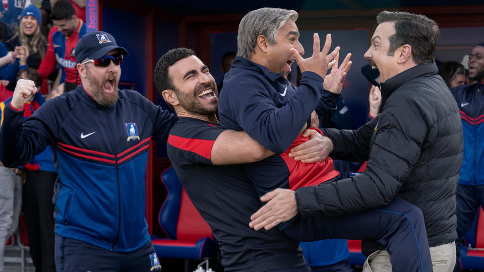 (L to R) Brendan Hunt as Coach Beard, Brett Goldstein as Roy Kent holding Nick Mohammed as Nathan 