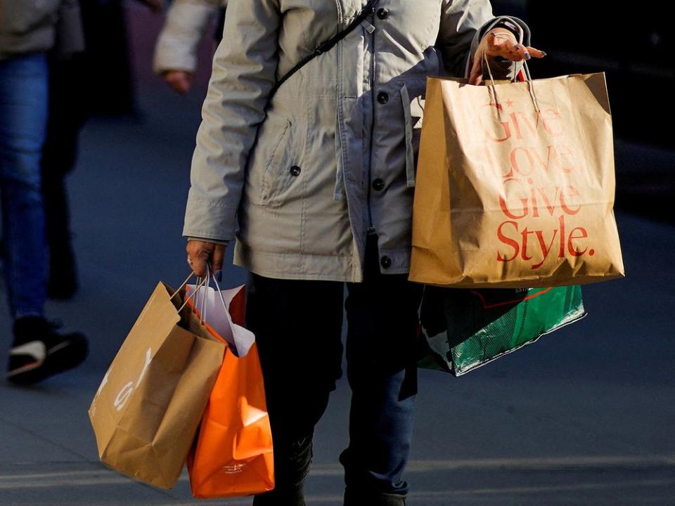 FILE PHOTO: FILE PHOTO: A woman carries shopping bags during the holiday season in New York