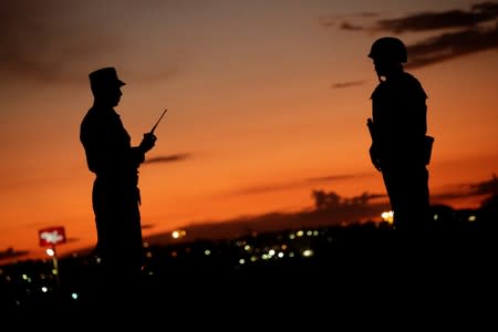 Soldiers assigned to the National Guard keep watch as part of an ongoing operation to prevent migrants from crossing illegally into the United States, in Ciudad Juarez