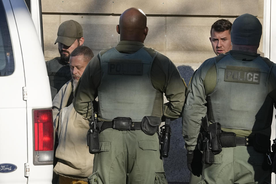 Officers escort Richard Matthew Allen, out of the Carroll County courthouse following a hearing, Tuesday, Nov. 22, 2022, in Delphi, Ind. Allen was charged last month with two counts of murder in the killings of Liberty German, 14, and Abigail Williams, 13. (AP Photo/Darron Cummings)