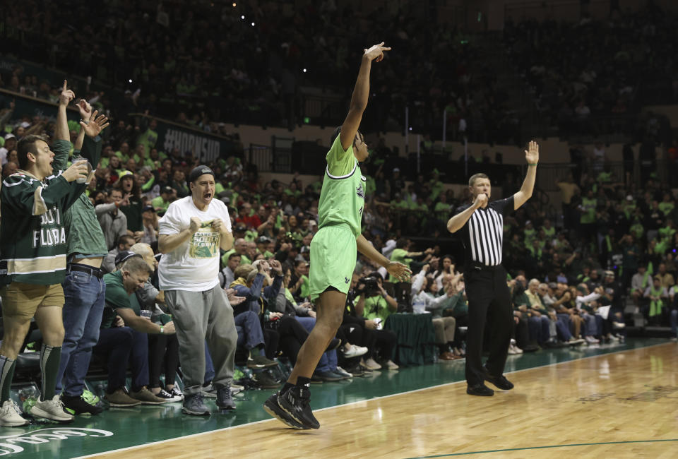 South Florid guard Chris Youngblood celebrates hitting a 3-point shot against Florida Atlantic during the first half of an NCAA college basketball game, Sunday, Feb. 18, 2024, in Tampa, Fla. (AP Photo/Scott Audette)