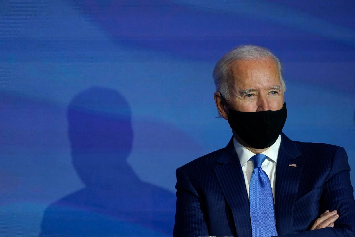 In this 11 December 2020, file photo President-elect Joe Biden listens during an event to announce his choice for several positions in his administration at The Queen theatre in Wilmington, Delaware ((Associated Press))