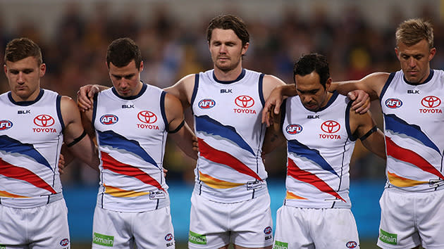 Patrick Dangerfield (centre) and the players remember their coach.