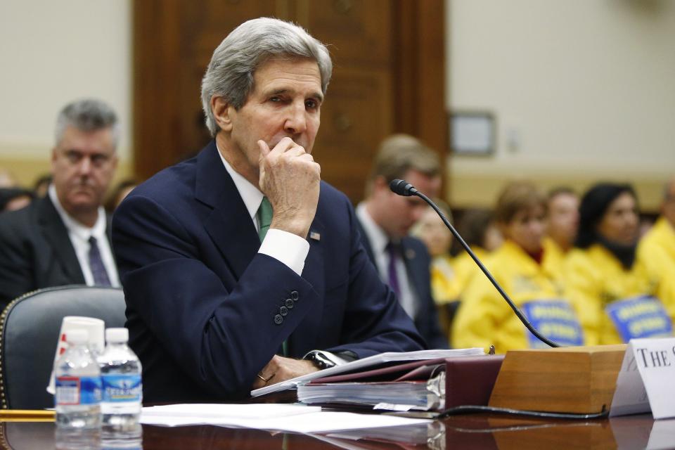 Kerry listens to opening statements as he waits to testify on agreements over Iran's nuclear programs, before the House Foreign Affairs Committee on Capitol Hill in Washington