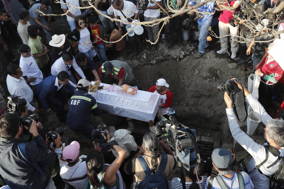 Family members bury 7-year-old murder victim Fatima in Mexico City, Tuesday, Feb. 18, 2020. Fatima's body was found wrapped in a bag and abandoned in a rural area on Saturday. Five people have been questioned in the case, and video footage of her abduction exists. (AP Photo/Marco Ugarte)